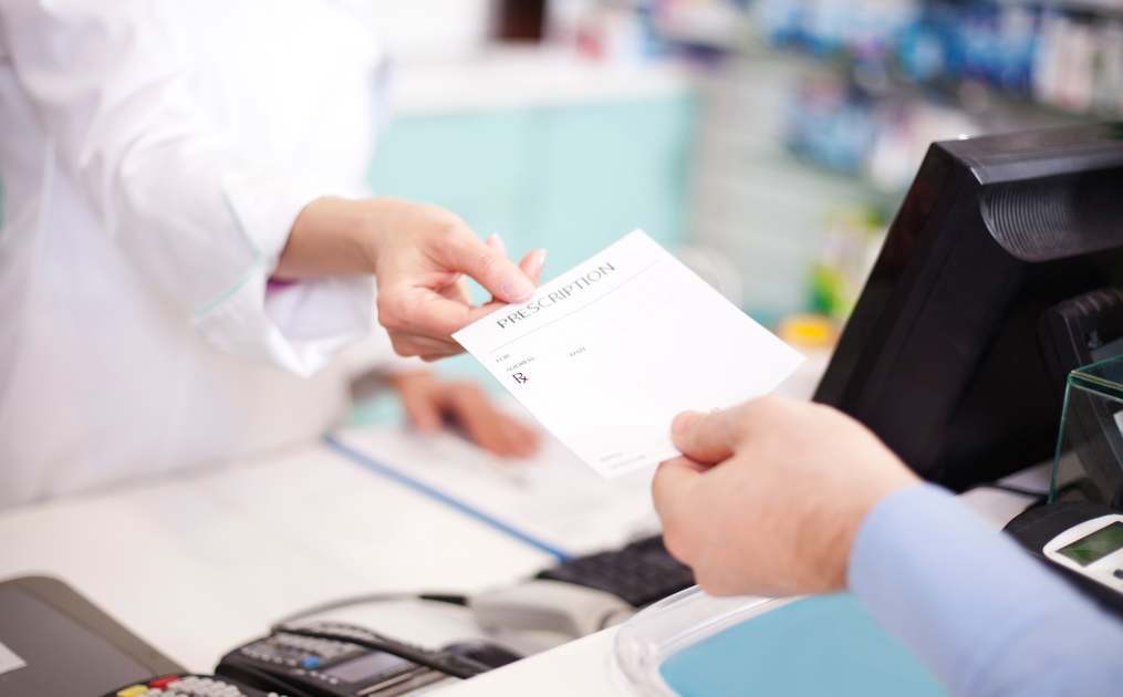 doctor handing person a prescription 